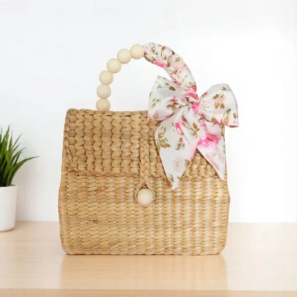 Malai straw handbag with floral bow and wooden handle