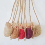 Apsara straw tote bag with shoulder strap and drawstring top, handcrafted from water hyacinth in Thailand