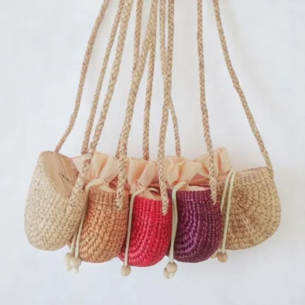 Apsara straw tote bag with shoulder strap and drawstring top, handcrafted from water hyacinth in Thailand