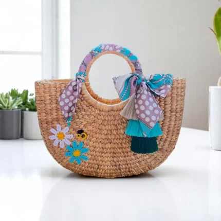 Woven straw bag with raffia tassels and floral embroidery