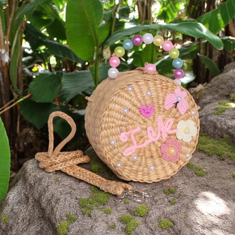 Choraka round kids straw bag with pastel bead handle and name embroidery.