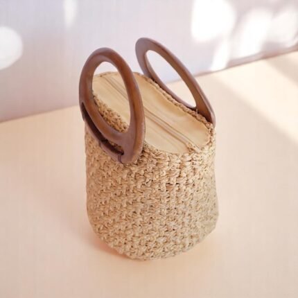 Handmade water hyacinth straw bucket bag with wooden handles and natural weave