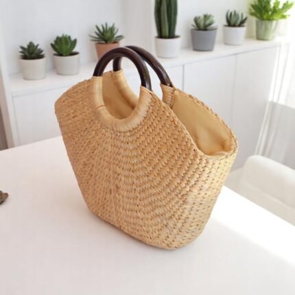 Natural straw tote bag with circular wooden handles and soft lining