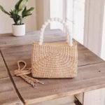 Straw mini bag with white bead handle and detachable crossbody strap