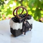 Black straw purse with wooden handles and lace trim
