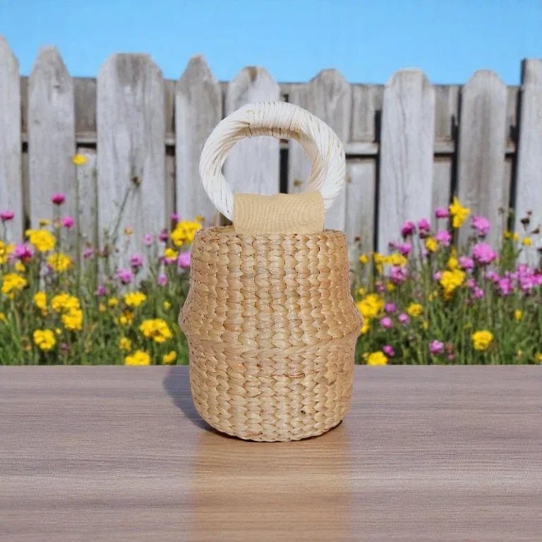 Sculpted straw bucket bag with wrapped round white handle