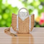 Pimwara Pearl Handle Ladies Straw Bag – handcrafted crescent straw bag with pearl handle, drawstring cotton lining, and white ribbon detail