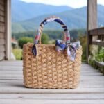 Chanisa Navy Ribbon Wedding Straw Tote – handmade bridal straw bag with navy and gold ribbon bows, structured rectangular shape, and vegan straw weave