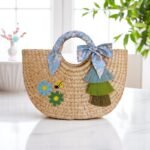 Duangjai Floral Tassel Summer Straw Tote – round straw bag with tassels, ribbon handle, ladybird embroidery and floral appliqués