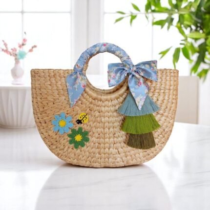 Duangjai Floral Tassel Summer Straw Tote – round straw bag with tassels, ribbon handle, ladybird embroidery and floral appliqués