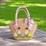 Nongnuch Straw Floral Handle Wedding Bag – bridal straw tote with floral ribbon handles, bee and daisy embroidery, handmade in Thailand