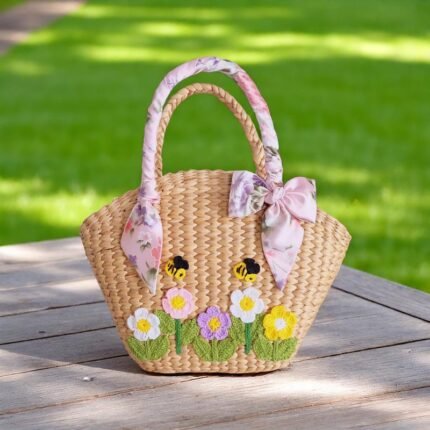 Nongnuch Straw Floral Handle Wedding Bag – bridal straw tote with floral ribbon handles, bee and daisy embroidery, handmade in Thailand